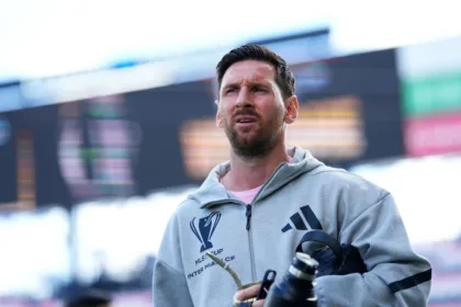 Inter Miami Players Celebrating With Lionel Messi In Front Of Cheering Supporters After A Goal In An Mls Match.